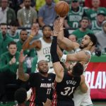 
              Boston Celtics' Jayson Tatum shoots against Miami Heat's Max Strus (31) and P.J. Tucker (17) during the first half of Game 3 of the NBA basketball playoffs Eastern Conference finals Saturday, May 21, 2022, in Boston. (AP Photo/Michael Dwyer)
            