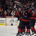 
              Carolina Hurricanes celebrate an overtime goal by Ian Cole against the New York Rangers in Game 1 of an NHL hockey Stanley Cup second-round playoff series in Raleigh, N.C., Wednesday, May 18, 2022. (AP Photo/Karl B DeBlaker)
            