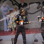 
              Winner Red Bull driver Sergio Perez of Mexico, center, sprays champagne to his teammate third placed Red Bull driver Max Verstappen and Ferrari driver Carlos Sainz of Spain on the podium of the Monaco Formula One Grand Prix, at the Monaco racetrack, in Monaco, Sunday, May 29, 2022. (AP Photo/Daniel Cole)
            