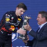 
              Red Bull driver Max Verstappen of the Netherlands receives the winner's trophy from former Miami Dolphins quarterback Dan Marino at the Formula One Miami Grand Prix auto race at the Miami International Autodrome, Sunday, May 8, 2022, in Miami Gardens, Fla. (AP Photo/Lynne Sladky)
            