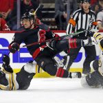 
              Carolina Hurricanes' Max Domi (13) is tripped up by Boston Bruins' Erik Haula (56) during the first period of Game 5 of an NHL hockey Stanley Cup first-round playoff series in Raleigh, N.C., Tuesday, May 10, 2022. (AP Photo/Karl B DeBlaker)
            