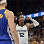 
              Memphis Grizzlies guard Ja Morant (12) reacts after scoring as Golden State Warriors guard Klay Thompson (11) looks on during Game 1 of a second-round NBA basketball playoff series Sunday, May 1, 2022, in Memphis, Tenn. (AP Photo/Brandon Dill)
            