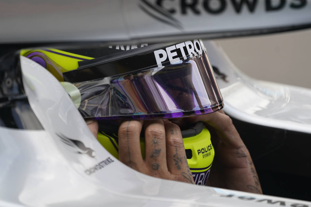 Mercedes driver Lewis Hamilton of Britain sits in his car during the second practice session for th...