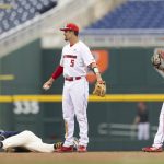 
              Rutgers' Danny DiGeorgio (5) and Garrett Callaghan, right, react after Michigan's Ted Burton, left, safely stole second base ahead of a tag by DiGeorgio in the fourth inning of the NCAA college Big Ten baseball championship game Sunday, May 29, 2022, at Charles Schwalb Field in Omaha, Neb. (AP Photo/Rebecca S. Gratz)
            