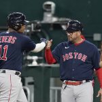 
              Boston Red Sox's Rafael Devers (11) gets a fist bump from first base coach Ramon Vazquez after hitting an RBI single against the Texas Rangers during the third inning of a baseball game in Arlington, Texas, Friday, May 13, 2022. (AP Photo/LM Otero)
            