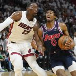 
              Philadelphia 76ers guard Tyrese Maxey (0) drives to the basket as Miami Heat center Bam Adebayo (13) defends, during the first half of Game 2 of an NBA basketball second-round playoff series, Wednesday, May 4, 2022, in Miami. (AP Photo/Marta Lavandier)
            