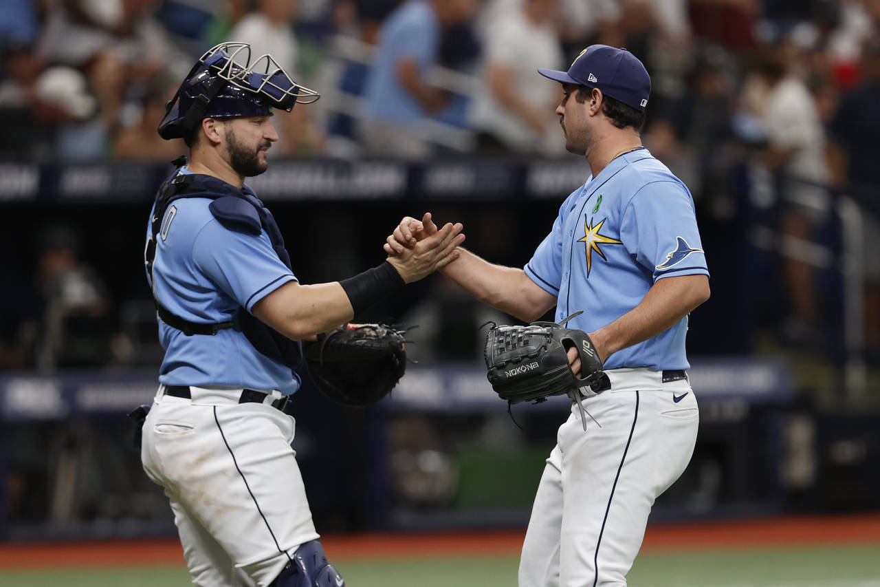 Tampa Bay Rays catcher Mike Zunino, left, celebrates with relief pitcher J.P. Feyereisen after a ba...