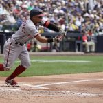 
              Washington Nationals' Cesar Hernandez bunts for an RBI single during the fourth inning of a baseball game against the Milwaukee Brewers Sunday, May 22, 2022, in Milwaukee. (AP Photo/Morry Gash)
            