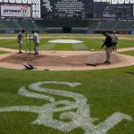 
              The Guaranteed Rate Field grounds crew work around home plate after a baseball game between the Chicago White Sox and the Cleveland Guardians was postponed due to multiple positive COVID-19 tests within the Guardians organization after Wednesday, May 11, 2022, in Chicago. (AP Photo/Charles Rex Arbogast)
            