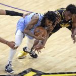
              Golden State Warriors' Jordan Poole, left, and Andrew Wiggins defends against Memphis Grizzlies' Ja Morant during the fourth quarter in Game 3 of NBA basketball playoffs Western Conference semifinal in San Francisco on Saturday, May 7, 2022. (Scott Strazzante/San Francisco Chronicle via AP)
            