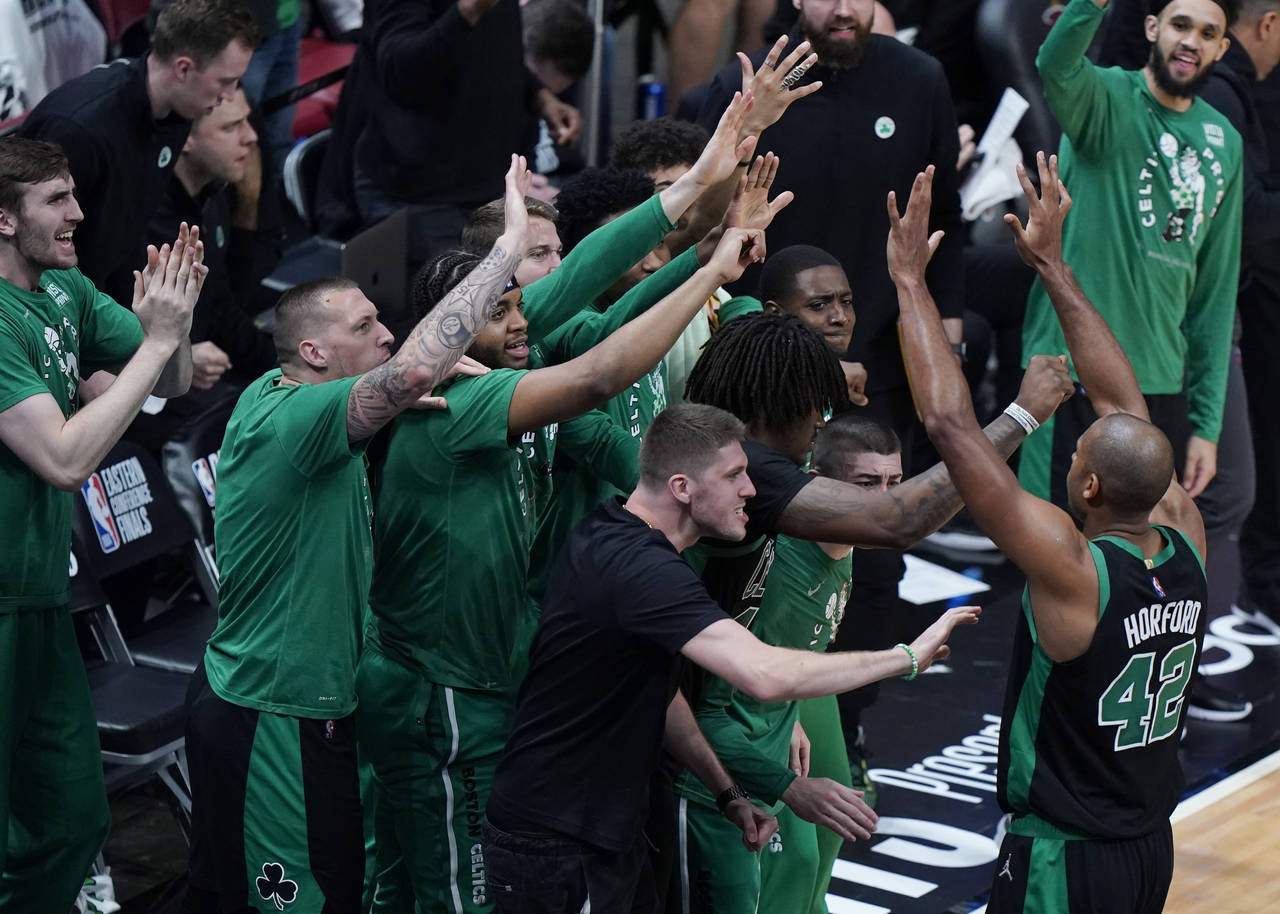 Boston Celtics center Al Horford (42) is congratulated by his teammates during the second half of G...