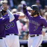 
              Colorado Rockies' Brendan Rodgers, right, celebrates with C.J. Cron, center, and Randal Grichuk after after hitting a three-run home run in the fifth inning of a baseball game against the Washington Nationals, Thursday, May 5, 2022, in Denver. (AP Photo/David Zalubowski)
            