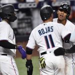 
              Miami Marlins' Erik Gonzalez, right, and Miguel Rojas (11) celebrate scoring runs during the seventh inning of a baseball game against the Washington Nationals as teammate Jazz Chisholm Jr. (2) looks on, Tuesday, May 17, 2022, in Miami. (AP Photo/Jim Rassol)
            