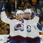 
              Colorado Avalanche center Nathan MacKinnon, left, celebrates with Mikko Rantanen, right, after MacKinnon scored an empty-net goal against the Nashville Predators to seal Colorado's win in the third period in Game 4 of an NHL hockey first-round playoff series Monday, May 9, 2022, in Nashville, Tenn. The Avalanche won 5-3 to sweep the series 4-0. (AP Photo/Mark Humphrey)
            