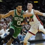 
              Boston Celtics forward Jayson Tatum (0) dribbles the ball as Miami Heat guard Tyler Herro (14) defends during the first half of Game 2 of the NBA basketball Eastern Conference finals playoff series, Thursday, May 19, 2022, in Miami. (AP Photo/Lynne Sladky)
            
