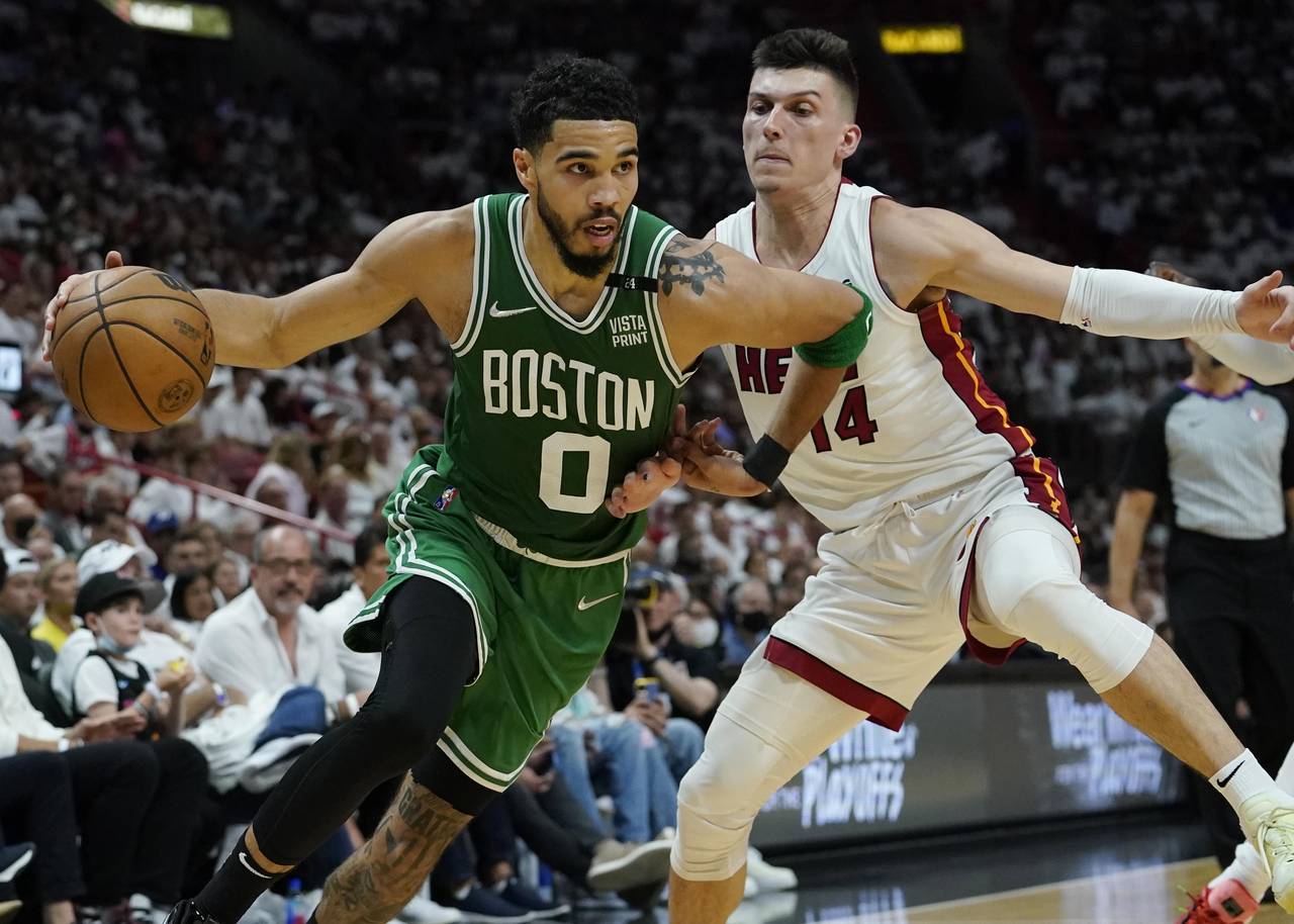 Boston Celtics forward Jayson Tatum (0) dribbles the ball as Miami Heat guard Tyler Herro (14) defe...