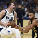 
              Dallas Mavericks guard Luka Doncic, left, is defended by Golden State Warriors guard Stephen Curry during the first half of Game 1 of the NBA basketball playoffs Western Conference finals in San Francisco, Wednesday, May 18, 2022. (AP Photo/Jed Jacobsohn)
            