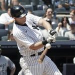 
              New York Yankees' DJ LeMahieu (26) hits a grand slam during the second inning of a baseball game against Chicago White Sox, Saturday, May 21, 2022, in New York. (AP Photo/Bebeto Matthews)
            