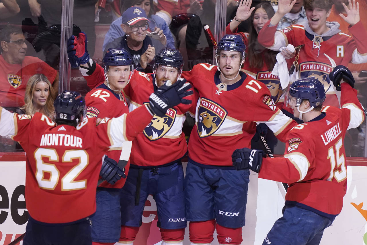 Florida Panthers teammates celebrate a goal by Florida Panthers left wing Mason Marchment (17) duri...