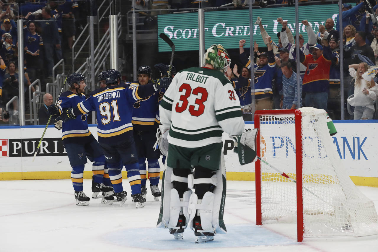 St. Louis Blues celebrate after a goal against Minnesota Wild goalie Cam Talbot during the second p...