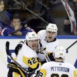 
              Pittsburgh Penguins center Evgeni Malkin (71) celebrates with teammates after scoring against the New York Rangers during the third overtime in Game 1 of an NHL hockey Stanley Cup first-round playoff series, Tuesday, May 3, 2022, in New York. The Penguins won 4-3. (AP Photo/Adam Hunger)
            