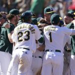 
              Oakland Athletics' Luis Barrera, right, is congratulated by teammates after hitting a three-run home run against the Los Angeles Angels during the ninth inning of the first baseball game of a doubleheader in Oakland, Calif., Saturday, May 14, 2022. (AP Photo/Jeff Chiu)
            