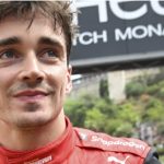 
              Ferrari driver Charles Leclerc of Monaco smiles after setting the pole position in the qualifying session at the Monaco racetrack, in Monaco, Saturday, May 28, 2022. The Formula one race will be held on Sunday. (Pool Photo/Christian Bruna/Via AP)
            