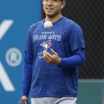 
              Toronto Blue Jays pitcher Yusei Kikuchi watches the team warm up before a baseball game against the Cleveland Guardians, Thursday, May 5, 2022, in Cleveland. (AP Photo/Ron Schwane)
            