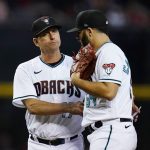 
              Arizona Diamondbacks manager Torey Lovullo, left, talks with Diamondbacks starting pitcher Humberto Castellanos, right, after Lovullo removes the pitcher during the fifth inning of a baseball game against the Atlanta Braves Tuesday, May 31, 2022, in Phoenix. (AP Photo/Ross D. Franklin)
            