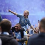 
              Manchester City fans celebrate after the English Premier League soccer match between Manchester City and Aston Villa at the Etihad Stadium in Manchester, England, Sunday, May 22, 2022. Manchester City won the match against Aston Villa and secured the 2022 Premier League title. (AP Photo/Dave Thompson)
            