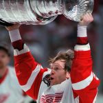 
              FILE- Detroit Red Wings hockey team defenseman Vladimir Konstantinov raises the Stanley Cup in celebration after Detroit swept the NHL hockey Stanley Cup finals over the Philadelphia Flyers on June 7, 1997, in Detroit, six days before he was almost killed in a limousine crash. Konstantinov is in danger of losing the 24/7 care he has had for two-plus decades. The disabled former defenseman is a casualty of changes to Michigan's auto insurance law that curbed or cut what hospitals, residential care facilities and home providers can charge car insurers for care. (AP Photo/Tom Pidgeon, File)
            