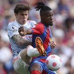 
              Manchester United's Victor Lindelof, left, tries to tackle Crystal Palace's Wilfried Zaha during the English Premier League soccer match between Manchester United and Crystal Palace at Selhurst Park stadium in London, Sunday, May 22, 2022. (AP Photo/Ian Walton)
            