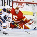
              Edmonton Oilers center Connor McDavid, left, tries to get the puck past Calgary Flames goalie Jacob Markstrom during the first period of Game 5 of an NHL hockey second-round playoff series Thursday, May 26, 2022, in Calgary, Alberta. (Jeff McIntosh/The Canadian Press via AP)
            