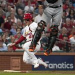 
              St. Louis Cardinals' Harrison Bader (48) scores past Baltimore Orioles catcher Robinson Chirinos as Chirinos leaps after the throw during the fourth inning of a baseball game Wednesday, May 11, 2022, in St. Louis. (AP Photo/Jeff Roberson)
            
