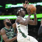 
              Milwaukee Bucks guard Jrue Holiday (21), right, drives toward the basket past Boston Celtics guard Jaylen Brown (7), left, in the first half of Game 1 in the second round of the NBA Eastern Conference playoff series, Sunday, May 1, 2022, in Boston. (AP Photo/Steven Senne)
            