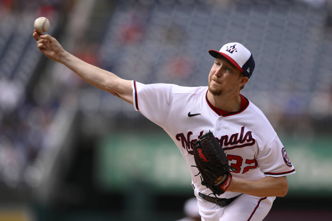 Washington Nationals starting pitcher Erick Fedde throws during the first inning of a baseball game...