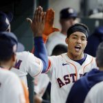 
              Houston Astros' Jeremy Pena, right, collects high-fives in the dugout after his home run against the Detroit Tigers during the fifth inning of a baseball game Thursday, May 5, 2022, in Houston. (AP Photo/Michael Wyke)
            