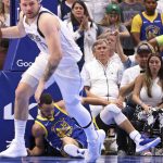 
              Golden State Warriors' Stephen Curry lies on the court as Dallas Mavericks' Luka Doncic dribbles during the third quarter in Game 4 of NBA basketball playoffs Western Conference finals in Dallas on Tuesday, May 24, 2022. (Scott Strazzante/San Francisco Chronicle via AP)
            