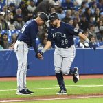 
              Seattle Mariners' Cal Raleigh, right, celebrates with third base coach Manny Acta after hitting a solo home run against the Toronto Blue Jays during the fifth inning of a baseball game in Toronto on Wednesday, May 18, 2022. (Jon Blacker/The Canadian Press via AP)
            