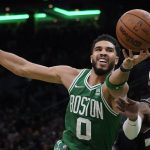 
              Boston Celtics forward Jayson Tatum (0) reaches for the ball next to Milwaukee Bucks guard Wesley Matthews during the second half of Game 2 of an Eastern Conference semifinal in the NBA basketball playoffs Tuesday, May 3, 2022, in Boston. (AP Photo/Charles Krupa)
            