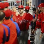 
              Philadelphia Phillies starting pitcher Aaron Nola gets high-fives in the dugout after going 8 1/3 innings against the Atlanta Braves in a baseball game Thursday, May 26, 2022, in Atlanta. (Curtis Compton/Atlanta Journal-Constitution via AP)
            