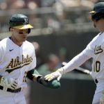 
              Oakland Athletics' Ramon Laureano (22) is congratulated by Chad Pinder (10) after scoring in the first inning of a baseball game against the Minnesota Twins in Oakland, Calif., on Wednesday, May 18, 2022. (AP Photo/Scot Tucker)
            