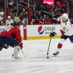 
              Florida Panthers center Sam Bennett (9) shoots past Washington Capitals defenseman Dmitry Orlov (9) during the second period of Game 3 in the first-round of the NHL Stanley Cup hockey playoffs, Saturday, May 7, 2022, in Washington. (AP Photo/Alex Brandon)
            