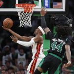 
              Miami Heat's Jimmy Butler shoots against Boston Celtics' Robert Williams III (44) during the second half of Game 6 of the NBA basketball playoffs Eastern Conference finals Friday, May 27, 2022, in Boston. (AP Photo/Michael Dwyer)
            