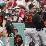 
              Baltimore Orioles' Robinson Chirinos (23) celebrates his two-run home run that also drove in Ramon Urias (29) during the fifth inning of the first game of a baseball doubleheader against the Boston Red Sox, Saturday, May 28, 2022, in Boston. (AP Photo/Michael Dwyer)
            