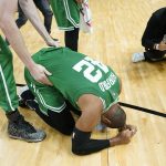 
              Boston Celtics center Al Horford (42) falls to his knees after winning Game 7 of the NBA basketball Eastern Conference finals playoff series against the Miami Heat, Sunday, May 29, 2022, in Miami. (AP Photo/Lynne Sladky)
            