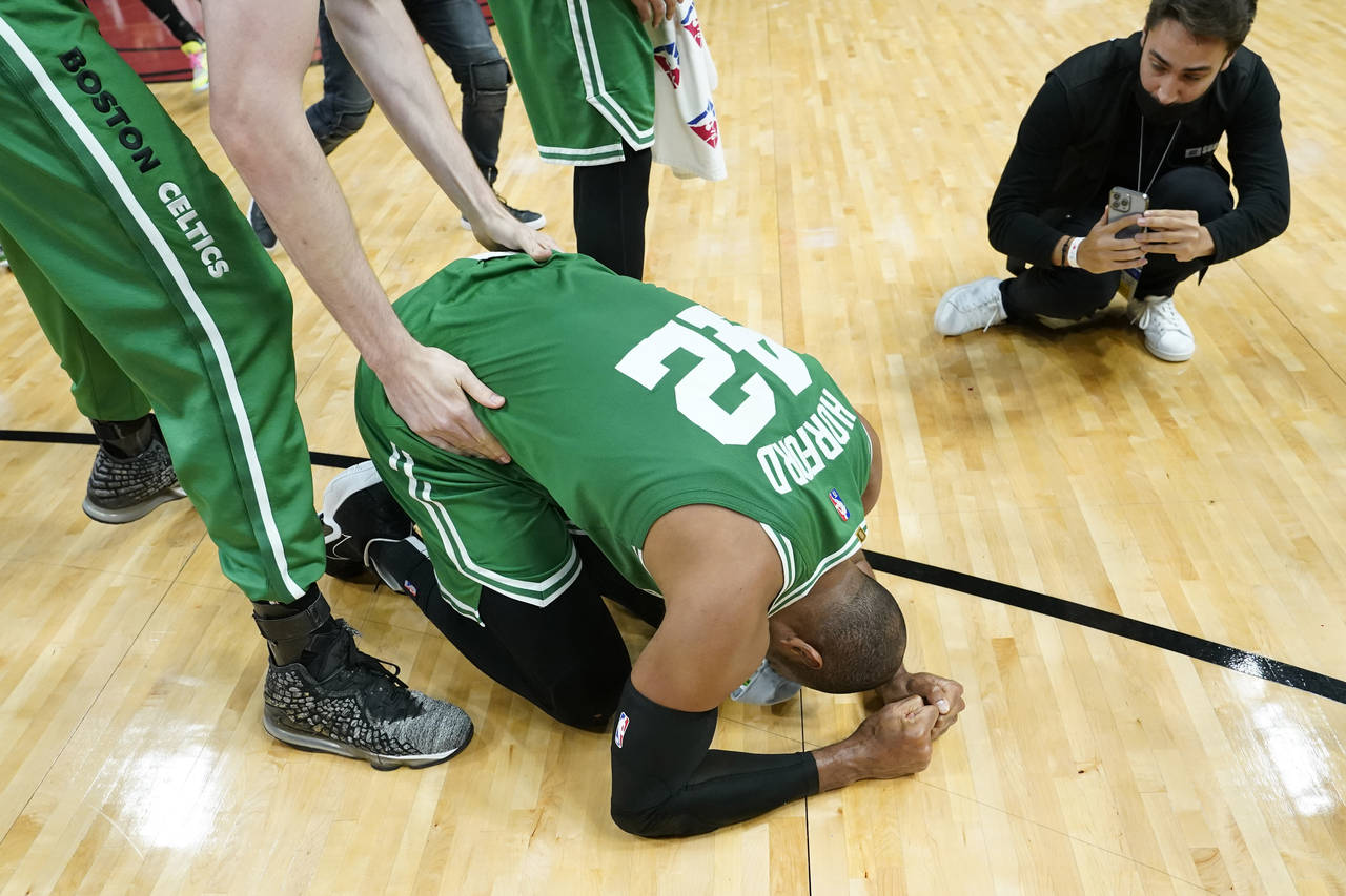 Boston Celtics center Al Horford (42) falls to his knees after winning Game 7 of the NBA basketball...