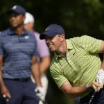 
              Rory McIlroy, of North Ireland, watches his tee shot as Tiger Woods looks on, on the 17th hole during the first round of the PGA Championship golf tournament, Thursday, May 19, 2022, in Tulsa, Okla. (AP Photo/Eric Gay)
            