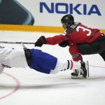 
              France's Charles Bertrand is challenged by Canada's Cole Sillinger, right, during the group A Hockey World Championship match between Canada and France in Helsinki, Finland, Tuesday May 24 2022. (AP Photo/Martin Meissner)
            