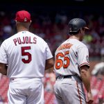 
              Baltimore Orioles' Rylan Bannon (65) stands next to St. Louis Cardinals first baseman Albert Pujols (5) after hitting a single on his first major league at bat during the second inning of a baseball Thursday, May 12, 2022, in St. Louis. (AP Photo/Jeff Roberson)
            